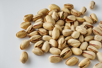 Fresh Pistachios: Nutritious Green Nuts on a White Background