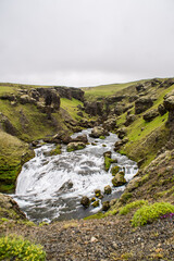 Skógafoss waterfall in Iceland on a cloudy summer day