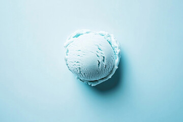 A top-down view of a light blue ice cream scoop on a light blue background.