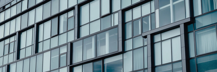 Facade of contemporary office building highlights its glass architecture under bright daylight