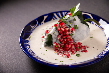 Chiles en Nogada, Typical dish from Mexico. Prepared with poblano chili stuffed with meat and...