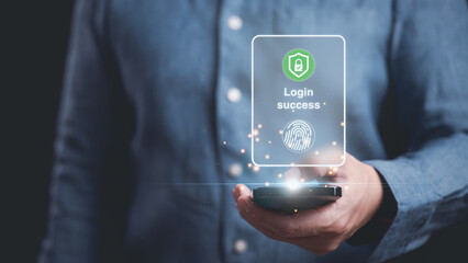A man is holding a cell phone with a green lock symbol with check mark and fingerprint icon in concept of authentication protection using fingerprint biometrics.