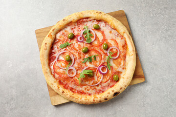 Delicious vegetarian pizza on light grey background, top view