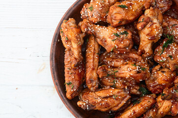 Caramelized in sause chicken wings  . Bar-b-q food background photo
