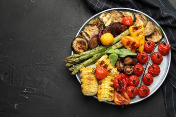 Delicious grilled vegetables on grey textured table, top view. Space for text