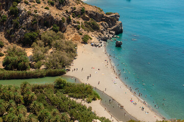 Preveli Beach, Crete, Greece- July 18, 2024: People at The Cretan Sea, Preveli Beach in summer season