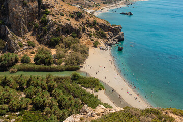 Obraz premium Preveli Beach, Crete, Greece- July 18, 2024: People at The Cretan Sea, Preveli Beach in summer season