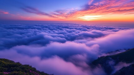 Fototapeta premium Majestic Sunrise Above the Clouds in Mountain Range - Breathtaking aerial view of a sunrise casting vibrant hues over a sea of clouds and distant mountain peaks. Perfect for nature lovers.