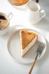 Caramel Cheesecake And Cup Of Coffee On White Table, Breakfast Or Coffee Break At Cafe