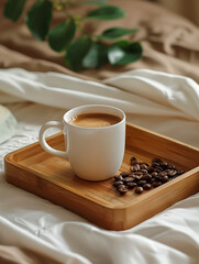 Serene unmade bed with spotless white linens and a coffee cup on a wooden tray, glowing in the morning light. Upscale hotel concept.