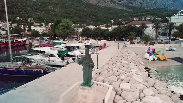 Aerial Reveal of St. Nicholas Statue at Nikolina Beach (Plaza Nikolina), Baska Voda, Croatia 