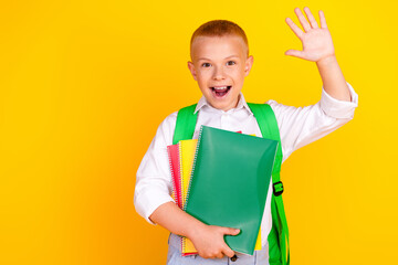 Photo of charming glad cheerful schoolkid wear white shirt 1st september hello sign isolated on yellow color background