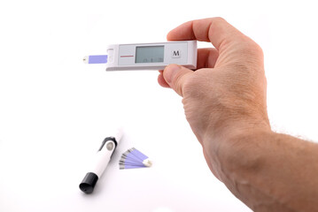 glucometer in a person's hand