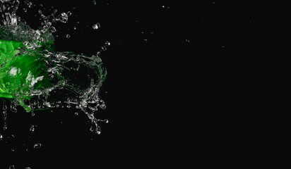Splashes of water pouring from a hose in the dark