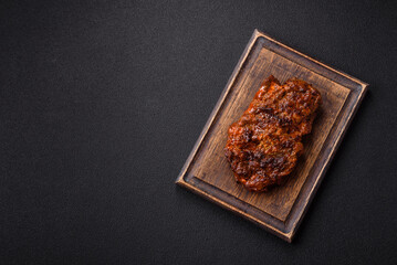 Fresh juicy delicious beef steak on a dark background