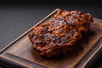 Fresh juicy delicious beef steak on a dark background