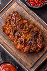 Fresh juicy delicious beef steak on a dark background