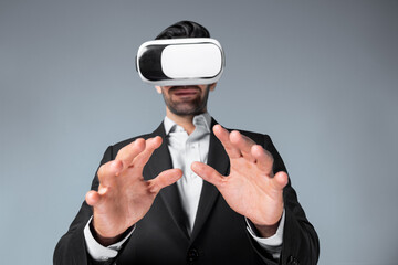 Smart business man with suit holding something while VR goggle to connect metaverse. Professional project manager looking at hologram by using visual reality headset. Technology innovation. Deviation.