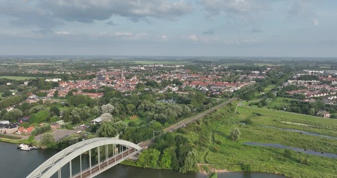Kuilenburgse Spoorbrug at Culemborg, city skyline along the Lek river. Gelderland, The Netherlands.