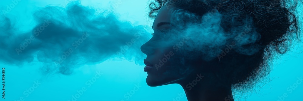 Poster A conceptual portrait silhouette of a woman with curly hair, exhaling smoke against an azure background