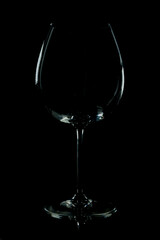 Empty wine glass on a black background. Isolated, close up