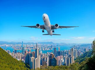 Passenger plane jet flies in blue sky over the city. Wonderful panoramic of Hong Kong view from...
