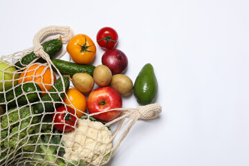 Delivery of vegetarian products. Bag with different vegetables and fruits on white background, top view