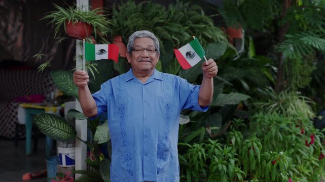 mexican mature man waving a mexican flag. Independence day concept