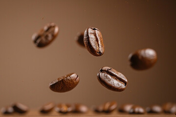 Fototapeta premium Invigorating morning, motivation to start the day concept. Levitating coffee beans flying above on brown studio background