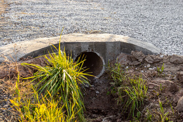 Car entrance through a drainage ditch. Concreted pipe