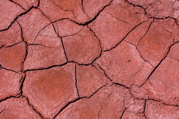 Cracked dry soil polluted with the iron ore. Environmental pollution. Global warming concept