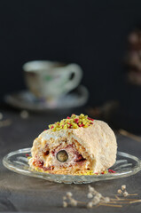 Close-up of a piece of fresh meringue roll on a dark background. Selective focus with copy space. Vertical shot