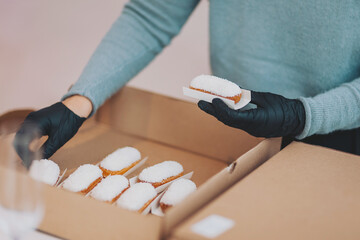 A professional confectioner makes and decorates delicious cakes. A lot of delicious cakes and desserts put up for guests. Delicious wedding reception candy bar dessert table.