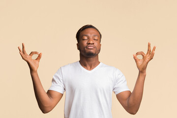 Fototapeta premium Keep Calm. Zen-Like Afro Guy Meditating Standing Over Yellow Background. Studio Shot, Copy Space
