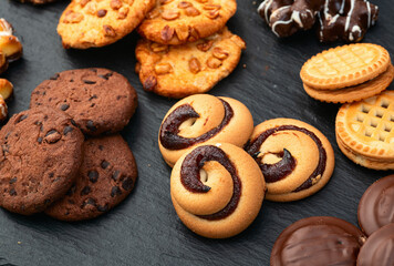 Mix of cookies . Many unhealthy snacks . Top view