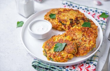 Corn fritters wih cream sauce in a plate