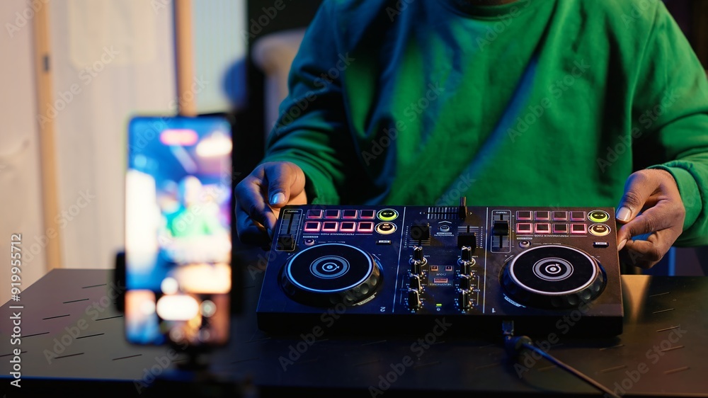 Leinwandbilder skilled audio engineer teaching online mixing tunes lessons by using smartphone on tripod to record 