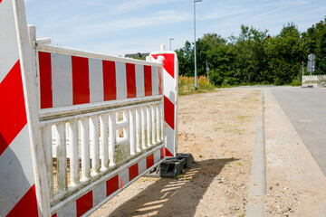 Red and white barrier at a construction site outdoors 