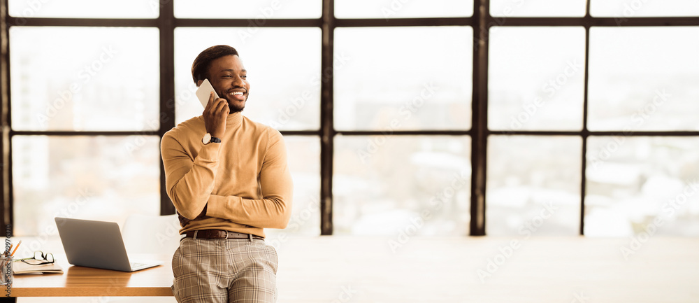 Poster business concept. african executive talking on smart phone solving business problems remotely. empty