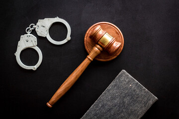 Judges gavel and police metal handcuffs, top view. Criminal offense and detention concept