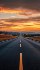 A winding road stretches into the horizon under a vibrant sunset, offering a sense of adventure and tranquility.