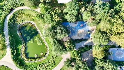 Aerial View of a Serene Park with a Pond and Playground