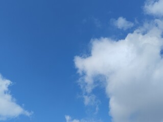White clouds and blue sky. The view of the clouds and sky is clear and calming
