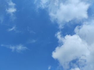 White clouds and blue sky. The view of the clouds and sky is clear and calming

