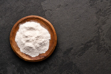 Baking soda in bowl - Healthy food. Green background