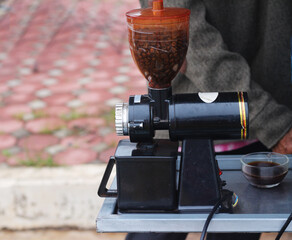 Coffee grinder with cup of coffee