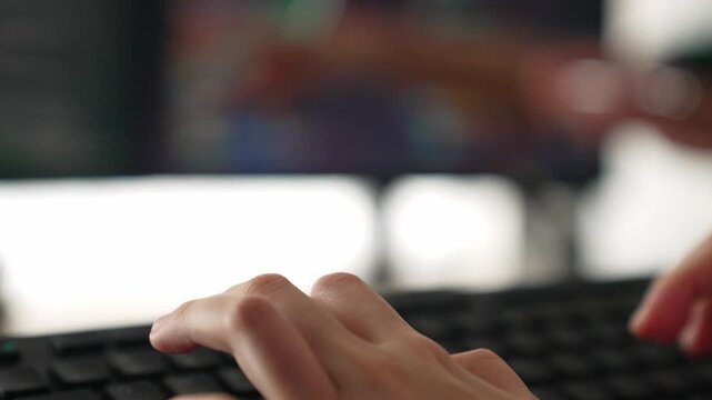 Slow motion closeup hand, back end software developer engineer for computer programming working together on debugging writing computing code, solving complex algorithms display on monitor. Burgeoning