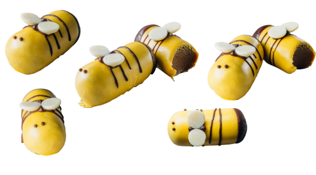 Bee cake pops on a plate over wooden background. Isolated