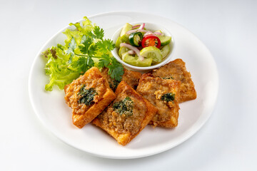 Fried Bread with Minced Pork Spread in white plate, traditional snacks and appetizers in Thailand