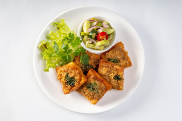 Fried Bread with Minced Pork Spread in white plate, traditional snacks and appetizers in Thailand